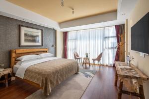 a bedroom with a large bed and a large window at Guilin cozy mountain retreat in Guilin +63 photos