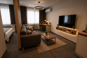 ein Wohnzimmer mit Sofa und Flachbildfernseher in der Unterkunft Kaçkar Otel in Rize