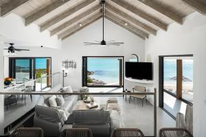a living room with a view of the ocean at Opaline Villa 4BR 2Bath-Ocean Front in Providenciales