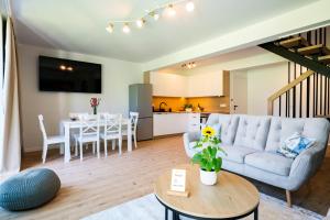 a living room with a couch and a table at Ostoja Lubiatowo in Lubiatowo