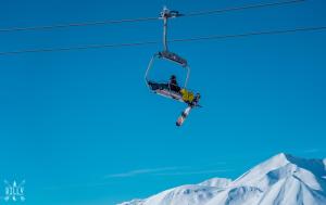 a skier on a ski lift in the air at New Gudauri Viva Seasons in Gudauri