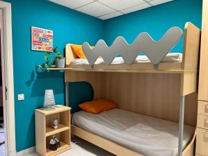 a bedroom with two bunk beds and a blue wall at Flat 3 in Mġarr +31 photos