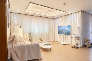 a living room with a couch and a table at Stay GAON in Seoul