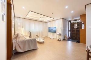 a living room with a couch and a table at Stay GAON in Seoul