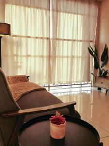 a hospital bed with a table in front of a window at Taiping Centre Point Suite 7 by BWC in Taiping