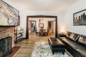 a living room with a couch and a fireplace at Minnehaha Falls Hideaway in Minneapolis