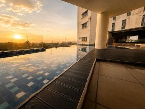 a swimming pool on the roof of a building at Taiping Centre Point Suite 7 by BWC in Taiping
