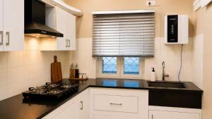 a kitchen with a stove and a sink and a window at Casa37 in Jaipur