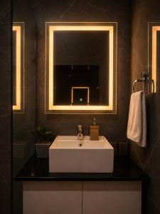 a bathroom with a white sink and a mirror at Casa37 in Jaipur +6 photos