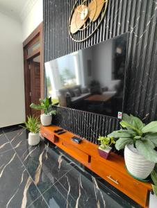 a living room with a table with potted plants at Panorama Safari Villa in Trincomalee