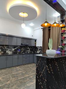 a kitchen with black granite counter tops and a large island at Panorama Safari Villa in Trincomalee