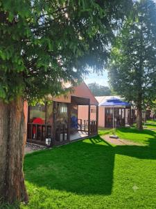a park with a playground and a building with trees at Cheongdo Apa Camp in Cheongdo