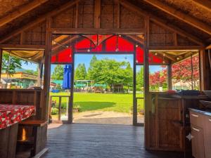 an open barn door with a view of a park at Cheongdo Apa Camp in Cheongdo