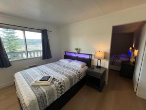 a bedroom with a large bed and a window at Stampeder Inn in Williams Lake