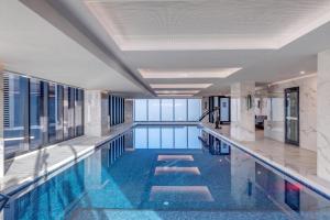 a swimming pool with blue water in a building at Skyline Views Premium 2B2B Free Parking Box Hill in Box Hill +12 photos