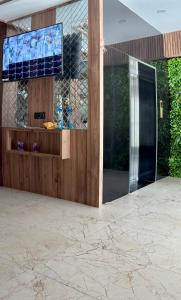 a lobby with a glass door and a television at Hotel RK Gharana Inn in Siwān