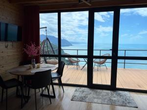 a dining room with a view of the ocean at Panorama Sarpi 2 in Batumi +13 photos