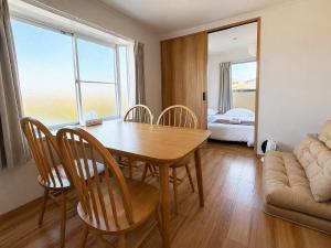 a dining room with a table and chairs and a bedroom at Ijiri Good Place House in Fukuoka