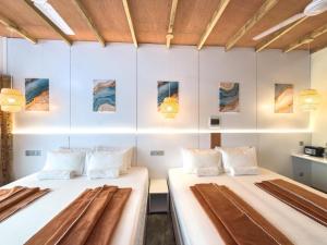 two beds in a room with white walls at Thundi Ocean View in Maalhos