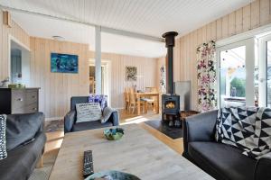 a living room with a couch and a table at Cozy Cottage At Tuse Næs In Holbæk in Holbæk