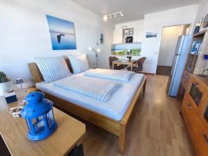 a large bed in a room with a table at Ferienwohnung Schlosser in Kiel