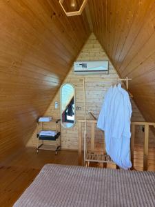 a bedroom with a bed in a wooden room at Panorama Sarpi in Batumi