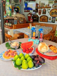 a table with plates of fruits and vegetables on it at B&B Zia Delia in Villaperuccio