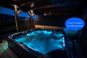 a jacuzzi tub in a cabin at night at Dream House Naftowa in Ustrzyki Dolne +67 photos