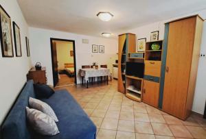 a living room with a blue couch and a table at Apartment Viola - Pavićini, Duga Uvala in Krnica