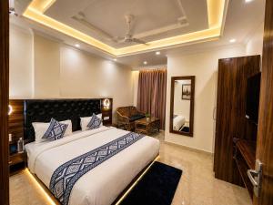 a hotel room with a bed and a mirror at Sitara Premium Gangotri Palace, Tapovan in Rishīkesh