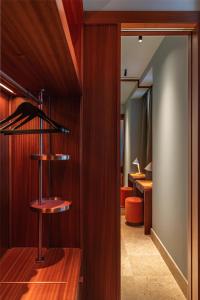 a room with a wooden wall with a book shelf at Andaz Lisbon, By Hyatt in Lisbon +83 photos
