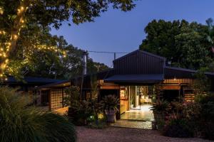 a house with a black roof with lights on it at The Bangalow Barn in Bangalow