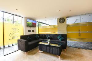 a living room with a couch and a table at Hotel Elvilla Model Town in New Delhi