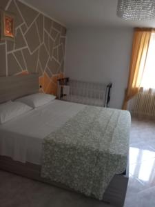 a bedroom with a large white bed in a room at Casa vacanze Melania in Cupra Marittima +4 photos