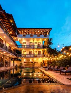 a hotel with a pool in front of a building at Nova By Horizon Collection in Unawatuna