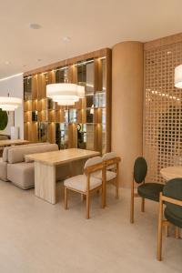 a living room with a table and chairs at Baitau Hotel Aktobe in Aktobe