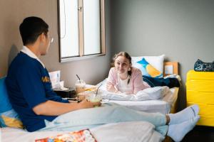 a man and a woman sitting in a hospital bed at BESTIE - Doyanen Hotels in Osaka +22 photos