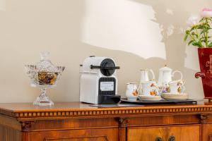 a table with a coffee maker and tea cups on it at Vila Ieva in Palanga +17 photos