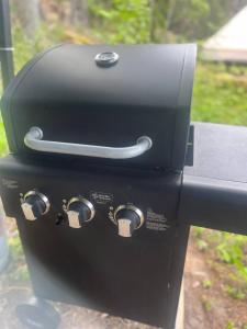 a black grill sitting on top of a table at Glamping - a living room overlooking the ocean in Hammarland