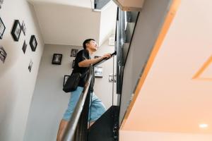 a man walking up the stairs in a house at YAMATO - Doyanen Hotels in Osaka