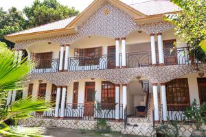 an old house with a balcony at Kivulini Homes in Arusha