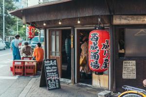 a restaurant with a sign in front of it at YAMATO - Doyanen Hotels in Osaka