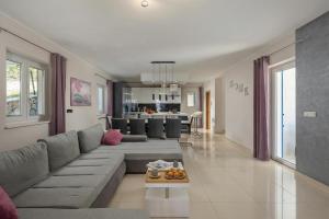 a large living room with a couch and a table at Villa Luka with Private Pool & Sea View in Labin