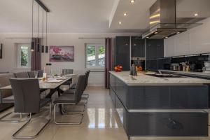 a kitchen with a long dining table and chairs at Villa Luka with Private Pool & Sea View in Labin