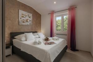 a bedroom with a bed with towels on it at Villa Luka with Private Pool & Sea View in Labin +37 photos