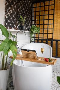 a bath tub with a table and a glass of wine at BlueHome Apartment in Vientiane +105 photos