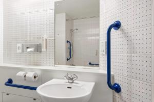 a bathroom with a sink and a mirror at Days Inn Hotel Sheffield South in Harthill