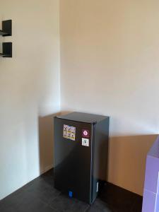 a black refrigerator with stickers on the side of a wall at Kubu Jimbaran in Jimbaran