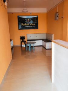 a room with a table and a tv on the wall at Perfect View Homestay in Cherrapunji +11 photos