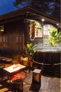 a backyard with a hot tub and a fountain at The Bangalow Barn in Bangalow